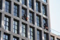 Two man is cleaning windows in New York City hanging outside on bulding on Varick Street Royalty Free Stock Photo