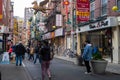 Bustling colorful decorated street with people in Chinatown NYC