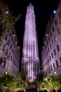 Rockefeller Center building in purple /pink color at night from channel gardens