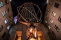 Statue of Atlas holding the world at Rockefeller Center at night