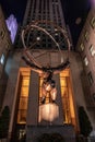 Statue of Atlas holding the world at Rockefeller Center at night