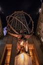 Statue of Atlas holding the world at Rockefeller Center at night