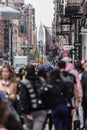 New York, NY, USA - May 17, 2018: Crowds of people walking sidewalk of Broadway avenue in Soho of Midtown Manhattan on