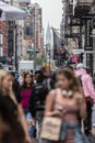 New York, NY, USA - May 17, 2018: Crowds of people walking sidewalk of Broadway avenue in Soho of Midtown Manhattan on