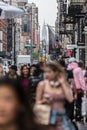 New York, NY, USA - May 17, 2018: Crowds of people walking sidewalk of Broadway avenue in Soho of Midtown Manhattan on