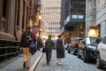 Pedestrians on cobblestone NY street Oktoberfest outdoor restaurants