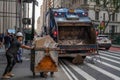 Sanitation workers with bins and trash truck in New York City street Royalty Free Stock Photo