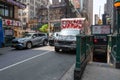 NYC 50th St subway entrance with cars and truck covered in street art Royalty Free Stock Photo