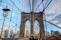 NEW YORK, OCT,25, 2013: View on famous NYC Brooklyn Bridge gate and walking people tourists. Famous New York bridge architecture. Royalty Free Stock Photo