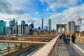 NEW YORK, OCT,25, 2013: View on famous NYC Brooklyn Bridge gate and walking people tourists. Famous New York architecture bridges. Royalty Free Stock Photo