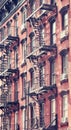 New York old building with fire escape, color toning applied, USA