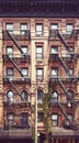 New York old townhouse with iron fire escape, color toning applied, USA