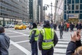 New York Police Department Officers Patroling the Neighborhood. Pedestrians and Vehicles Crossing the Road in New York City Royalty Free Stock Photo