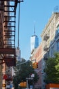 Soho street with cast iron buildings and Freedom tower in New York