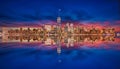 New York skyline from New Jersey on the blue hour with moon and reflection of skyscrapers on the Hudson river with lights on