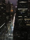 New York Streets with a stream of cars and high lighted skyscrapers against the night sky Royalty Free Stock Photo