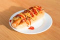New York style Hot Dog with sausage, mustard, chili, ketchup, onion and bits of bacon.