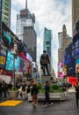 New York, Times Square. Scyscrapers, colorful neon lights, ads and George Cohan statue