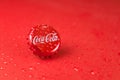 New York, UNITED STATES OF AMERICA - February 20, 2020: classic cap close-up of Coca-Cola on a blue background with drops of water