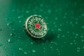 New York, UNITED STATES OF AMERICA - February 20, 2020: classic cap close-up of Heineken on a green background with drops of water Royalty Free Stock Photo