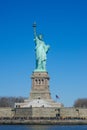 Vertical shot of the Statue of Liberty against the background of the blue sky. Royalty Free Stock Photo