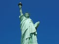 View of the Statue of Liberty against the background of the blue sky. Royalty Free Stock Photo