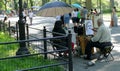 NEW YORK, UNITED STATES - AUGUST 25TH, 2016: An artist sketches a woman in Central Park on a summer day