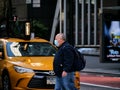 New York, United States, USA March 26, 2020: iconic picture of overweight man with mask in front of new york taxi during