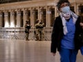 New York, United States, USA March 26, 2020: tired nurse walking through closed, empty grand central station during