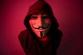 New York, USA - 22 april 2021: man wearing vendetta mask with hoodie on black background. This mask is symbol for Anonymous