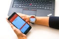 New York, USA - August 20, 2015: Business woman looking a the stock quotes on her smartwatch