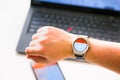 New York, USA - August 20, 2015: Man looking a the stock quotes on his smartwatch