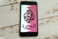 Black iPhone with logo of news media Al Jazeera on the screen. Royalty Free Stock Photo