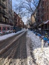 New York, USA - December 12: East Village street in Manhattan covered with pile of snow. Empty winter road with melting snow Royalty Free Stock Photo