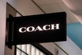 A logo of Coach brand on a side of a store in the mall of New York Airport Royalty Free Stock Photo