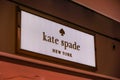 A logo of Kate Spade brand of a side of a store in the mall