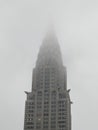 The top of the Chrysler Building covered in a dense fog. Royalty Free Stock Photo