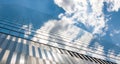 Modern futuristic glass facade of corporate finance office skyscraper business building architecture blue sky glass reflection. Royalty Free Stock Photo