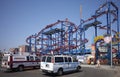 An ambulance and NYPD vehicle parked in front of Coney Island amusement park.