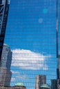 Skyscrapers reflected in a New York City building made from glass