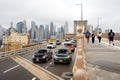 NEW YORK, USA - 11 JULY 2019: Traffic of people and cars on Brooklyn Bridge in foggy day Royalty Free Stock Photo