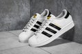 New York, USA - June 20 , 2023 : Adidas Superstar original white sneakers. Sport and fashion footware. white and black sneaker on