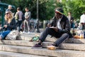 NEW YORK, USA - JUNE 3, 2018: Afro american man sitting in the park drawing. Manhattan street scene. Union square park. Royalty Free Stock Photo