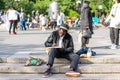 NEW YORK, USA - JUNE 3, 2018: Afro american man sitting in the park drawing. Manhattan street scene. Union square park. Royalty Free Stock Photo