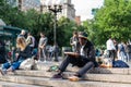 NEW YORK, USA - JUNE 3, 2018: Afro american man sitting in the park drawing. Manhattan street scene. Union square park. Royalty Free Stock Photo