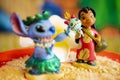 Close-up shot of Lilo figure in Background and in Focus and Stitch blurred out in foreground