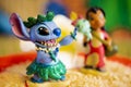 Close-up shot of Stitch figure in Foreground and in Focus and Lilo blurred out in background