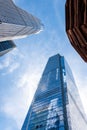 New York, USA - June 8, 2019: Low angle graphic view of skyscrapers and the Vessel building parts, sunny blue sky, New York City