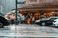 New York, USA - June 17, 2017: A man running through the road of busy downtown on a rainy stormy day. East 42nd street, Manhattan