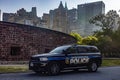 New York, USA June 1, 2023: NYPD official patrol car, with the Big Apple skyline and Manhattan in the background Royalty Free Stock Photo